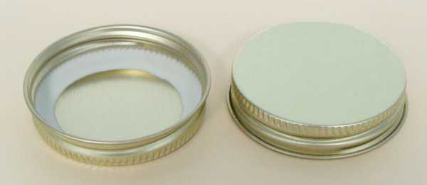 48-400 NATURAL THREADS, KNURLS, & CURL TIN-PLATE STEEL TIN-PLATE STEEL CONTINUOUS THREAD (CT) CAP WITH PLASTISOL LINER